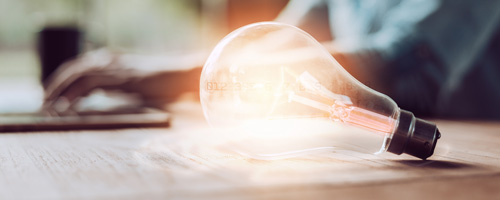 A lightbulb sitting on a desk.